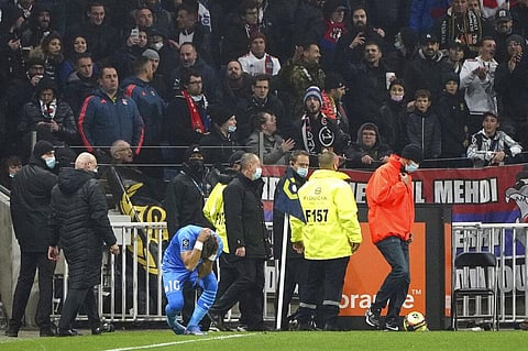 Marseille's Dimitri Payet reacts after being injured by an object thrown by a Lyon's supporter during Ligue 1 match in Decines, near Lyon, France, Sunday. (Photo | AP)