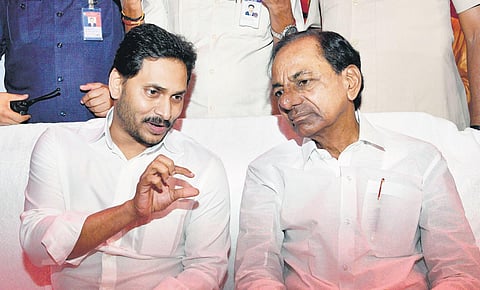 AP Chief Minister YS Jagan Mohan Reddy with his Telangana counterpart K Chandrasekhar Rao at a function in Shamshabad on Sunday I Express