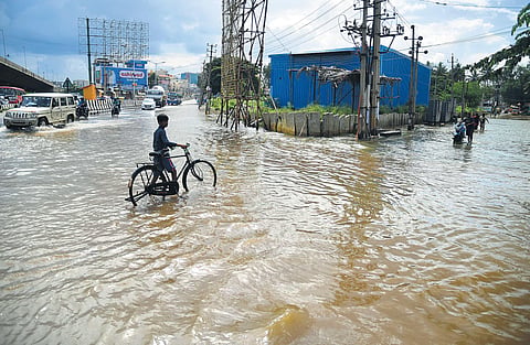 Heavy rain overnight has left roads close to Yelahanka lake submerged in knee-deep water, in Bengaluru on Monday | shriram bn