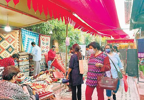 Patrons shopping from an array of handcrafted textiles. (Photo | Express)