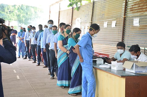 Students and staff of SDM Medical College in Dharwad queue up Covid19 test in college campus in Dharwad on Friday, Nov 26, 2021. (Photo | EPS)