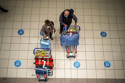 People wait at OR Tambo's airport in Johannesburg, South Africa. (Photo | AP)