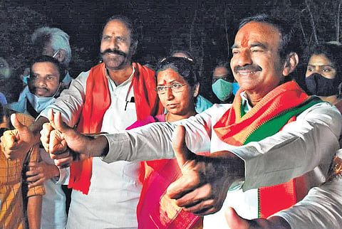 BJP candidate Eatala Rajender and wife Jamuna show a thumbs up to supporters after his victory in the Huzurabad Assembly bypoll