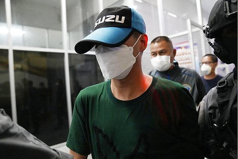 Police escort former police officer Thitisan Utthanaphon from the Crime Suppression Division in Bangkok, Thailand. (File Photo | AP)