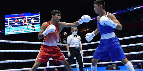 India's Akash Kumar (in Red) in action during his 54kg semi-final against Kazakhstan's Makhmud Sabyrkhan.