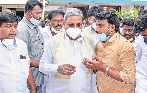 Congress Legislature Party leader Siddaramaiah listens patiently to a supporter in Mysuru on Monday | Udayshankar S