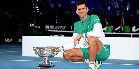 Serbia's Novak Djokovic poses with the Norman Brookes Challenge Cup after defeating Russia's Daniil Medvedev in the men's singles final at the Australian Open 2021. (Photo| AP)