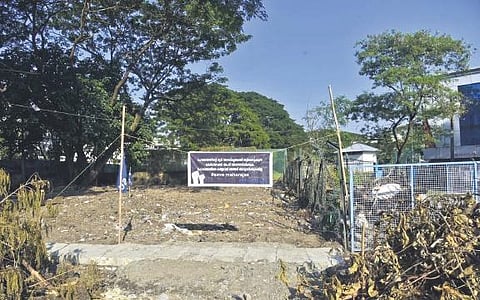 The patch of land near Maharaja’s College ground cleared by the corporation to rehabilitate vendors. The flex by KSU resisting the move can also be seen