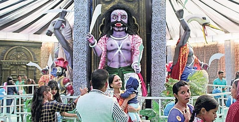 Visitors at Dhanu Yatra clicking pictures and selfies in front of the tableaux of Asuras. (File Photo)