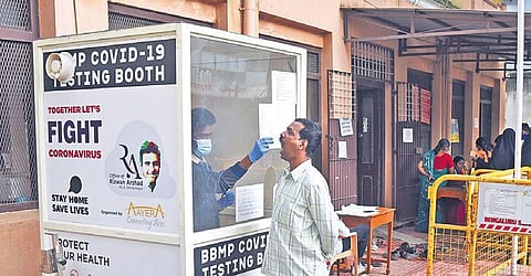 A health worker collects swab samples of a man at a primary health centre on Kamaraj Road in Bengaluru on Wednesday | Vinod Kumar T