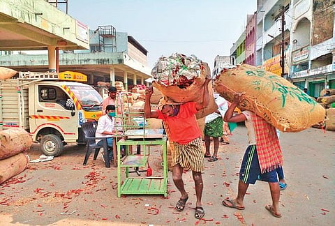 Workers unload dried red chilli produce at Old Malakpet Gunj (Photo | EPS, Vivek Bhoomi)