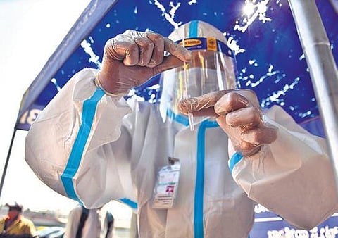 A health worker stores swab samples collected from a passenger at the KSRTC Bus Station on Saturday | Shriram BN