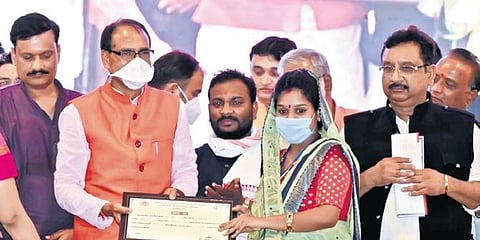 CM Shivraj Singh Chouhan with a beneficiary of the scheme | express