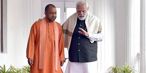 PM Narendra Modi (R) interacts with Uttar Pradesh CM Yogi Adityanath (Photo | Yogi Adityanath Twitter)