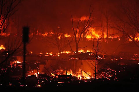 Homes burn as a wildfire rips through a development near Rock Creek Village, Denver. (Photo | AP)