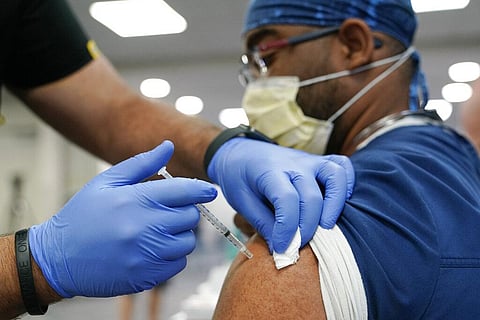 A healthcare worker receives a Pfizer COVID-19 booster shot at Jackson Memorial Hospital Tuesday, Oct. 5, 2021, in Miami. (Photo | AP)