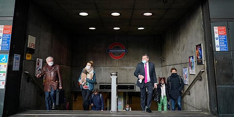 People wear face masks as they exit Westminster underground station, in London. (Photo| AP)
