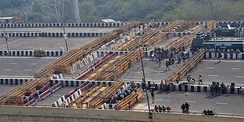 arricades put on the road at Delhi-Ghazipur border in New Delhi on Monday. (Photo| ANI)