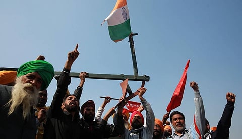Farmers raise slogans during their ongoing protest against the new farm laws at Singhu border in New Delhi on Sunday. (Photo | Shekhar Yadav/EPS)