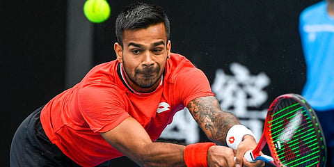 Sumit Nagal makes a backhand return to Ricardas Berankis during a tuneup tournament ahead of the Australian Open tennis championships in Melbourne. (Photo | AP)