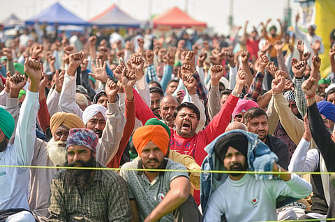 Farmers raise slogans during their protest against new farm laws at Ghazipur border in New Delhi.