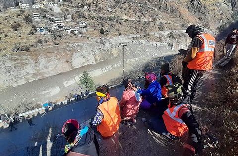 People watch as water level of Rishi Ganga river rises at chamoli in Joshimath, Uttrakhand on Thursday. (Photo | EPS/Shekhar Yadav)
