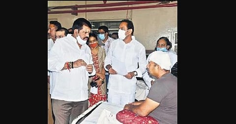 Ministers Alla Nani and M Srinivasa Rao speaking with the injured persons at KGH in Vizag on Saturday | Express
