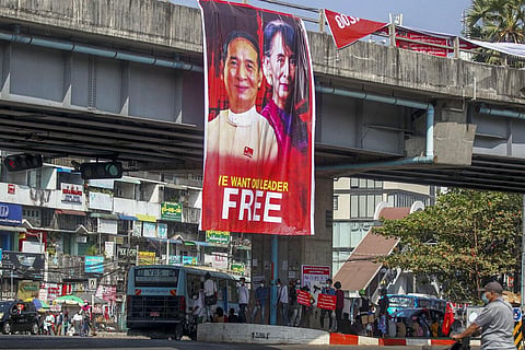 Pictures of detained Myanmar President Win Myint and leader Aung San Suu Kyi are displayed at an intersection against the military coup in Yangon, Myanmar. (Photo | AP)
