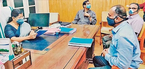 The photograph of Minister J Mercykutty Amma reportedly holding talks withrepresentatives of EMCC International, released by Ramesh Chennithala