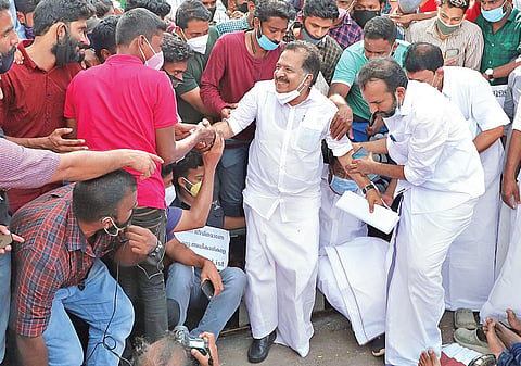 PSC civil police officer job aspirants help Opposition Leader Ramesh Chennithala get up, after he joined them in their protest in front of the Secretariat on Sunday | B P Deepu