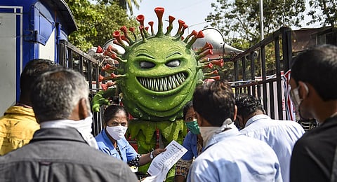 A BMC volunteer wearing coronavirus themed costume participates in a COVID-19 awareness campaign in Maharashtra. (File Photo | PTI)