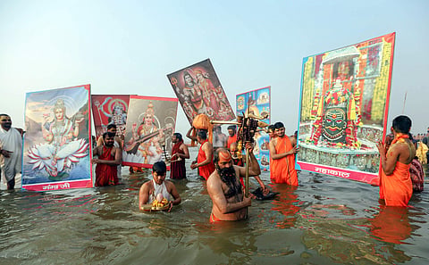 Sadhus offer prayers after taking a holy dip at Sangam confluence of River Ganga Yamuna and Saraswati on 'Mauni Amavasya' during the ongoing annual 'Magh Mela' festival in Prayagraj. (File | PTI)