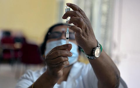 A health worker checks a syringe during a vaccination drive. (Photo | Meghana Sastry, EPS)