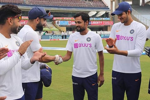 Shahbaz Nadeem receives the cap from Virat Kohli. (Photo | AP)