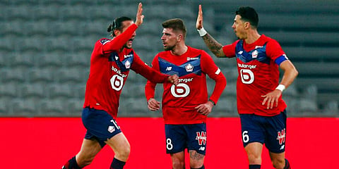From left, Lille's Yusuf Yazici, Xeka and Jose Fonte celebrate after a goal during their French League One match against Strasbourg. (Photo | AP)