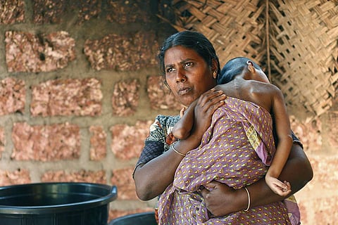Endosulfan survivor Arpitha lies on mother Usha's shoulder. (Photo | TP Sooraj, EPS)