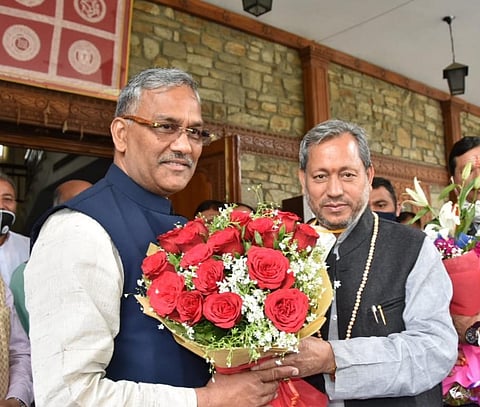Trivendra Singh Rawat meets Tirath Singh Rawat at Chief Minister's official residence. (Photo | Express)