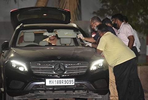 NIA officers investigate Sachin Vaze's Mercedes car, in connection with a probe into the recovery of explosives from a car parked near Mukesh Ambanis house. (Photo | PTI)