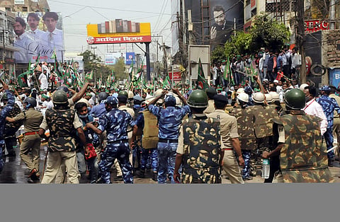 Security personnel try to stop Rashtriya Janata Dal supporters during their Vidhan Sabha protest march. (Photo | ANI)