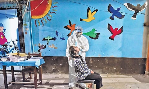 A health worker collects swab samples for coronavirus test at a Children’s Home in New Delhi. (File Photo | PTI)