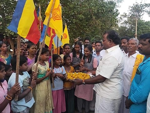 : PMK functionaries celebrating the 10.5 percent reservation for Vanniyars by distributing sweets to the people at a village in Ariyalur district. (Photo | Express)