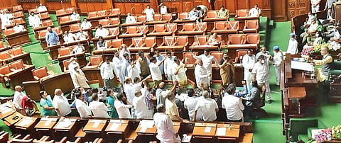 Congress legislators protest in the well of the House during a discussion on ‘One Nation, One Election’ idea in the Legislative Assembly, in Bengaluru on Friday