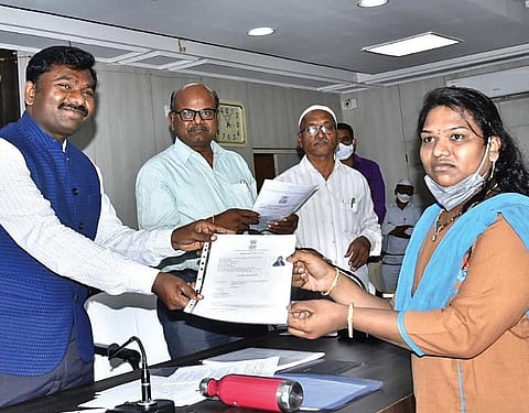 The Anantapur Collector handing-over an identity card to a transgender in the town on Saturday | Express