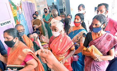 Beneficiaries waiting outside the Covid Vaccination Centre at Govt LP School, Kariyam in Thiruvananthapuram on Friday. (Photo | Vincent Pulickal, EPS)