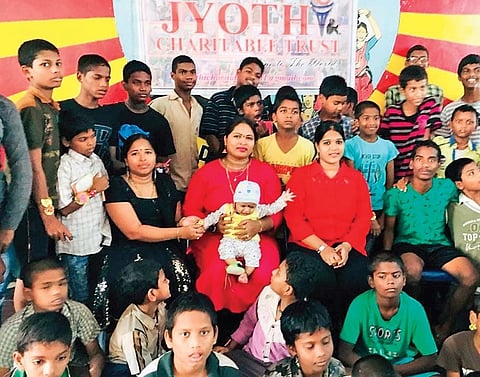 Jyothi poses with school students in Vijayawada | Express