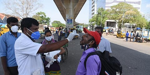 Health workers doing swab test on a traveller at Koyembedu, in Chennai. (Photo | R Satish Babu, EPS)