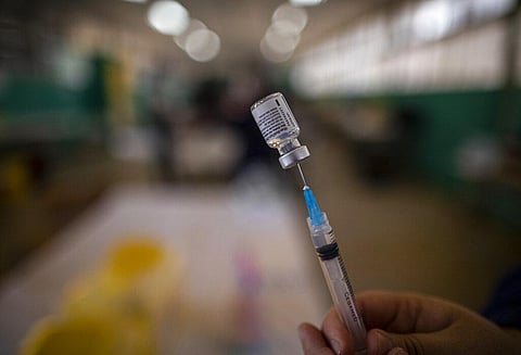 A health worker prepares a dose of the Pfizer vaccine for COVID-19 (Photo | AP)