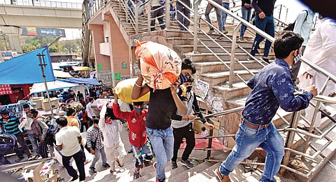 Migrant workers leave for their home states amid surge in Covid-19 cases at Kaushambi bus terminal in Ghaziabad. (Photo| Shekhar Yadav, EPS)