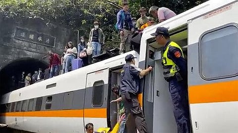 In this image made from a video released by hsnews.com.tw, passengers are helped to climb out of a derailed train in Hualien County in eastern Taiwan. (Photo | AP)