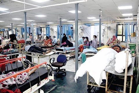 Patients rest in a Covid-19 ward while two dead bodies are kept nearby at the GTB hospital on Thursday. (Photo | EPS/Parveen negi)